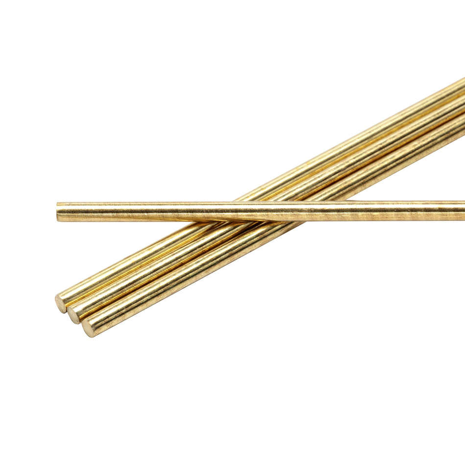 Four brass metal rods on a white background