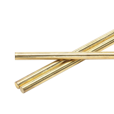 Three brass rods on a white background